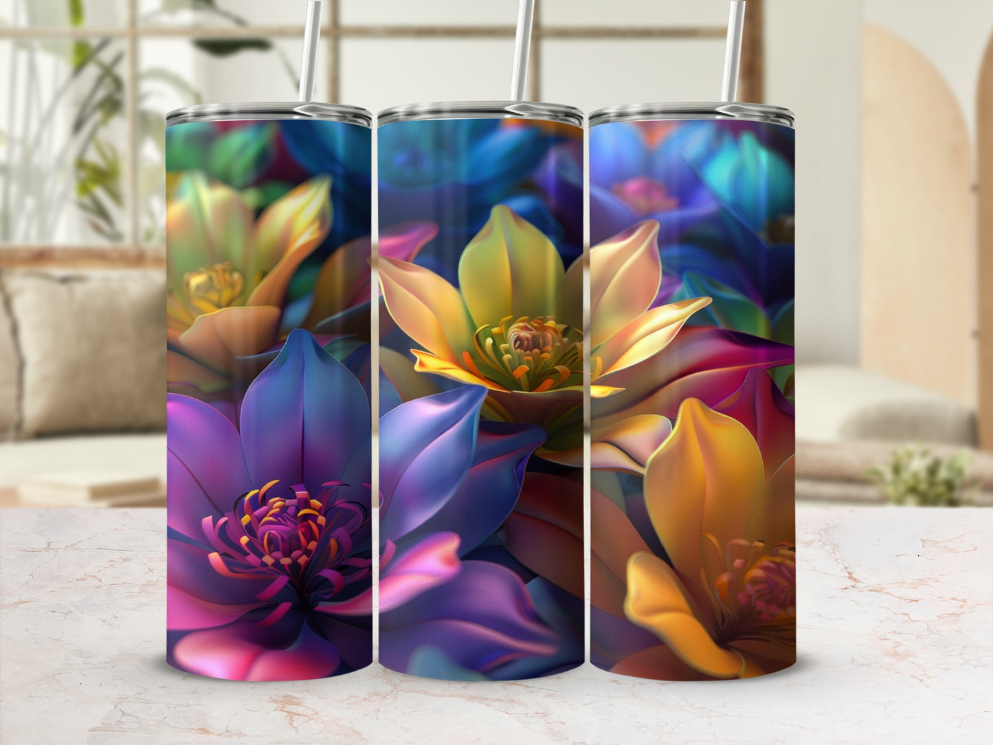 Three colorful floral tumblers with straws against a blurred background.
