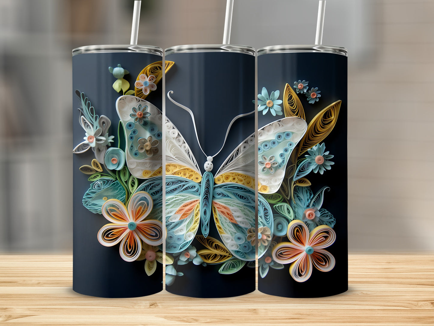 Three tumblers display quilled paper art of a butterfly and flowers on a dark background.