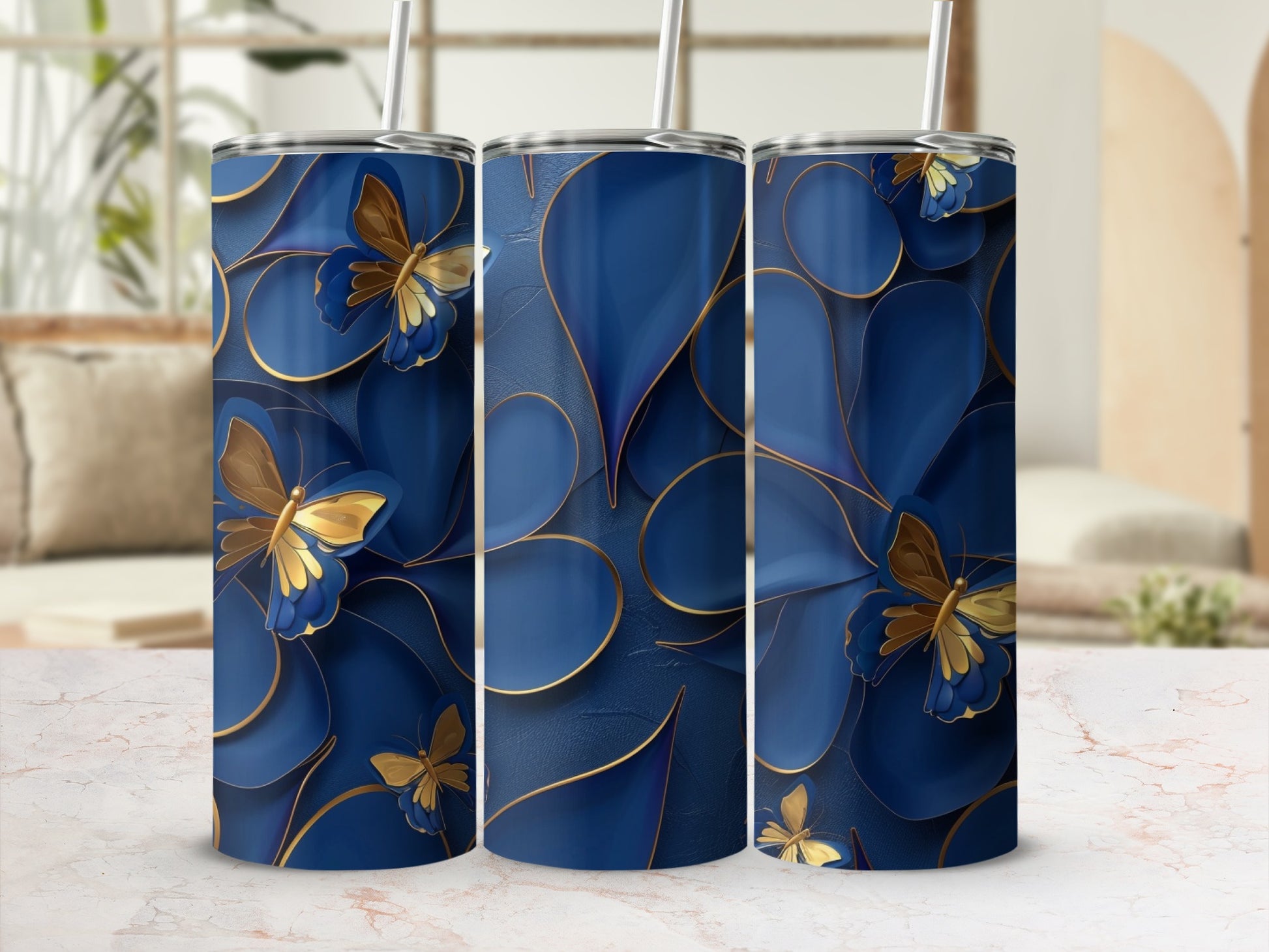 Three blue tumblers with gold butterfly accents and textured petals.