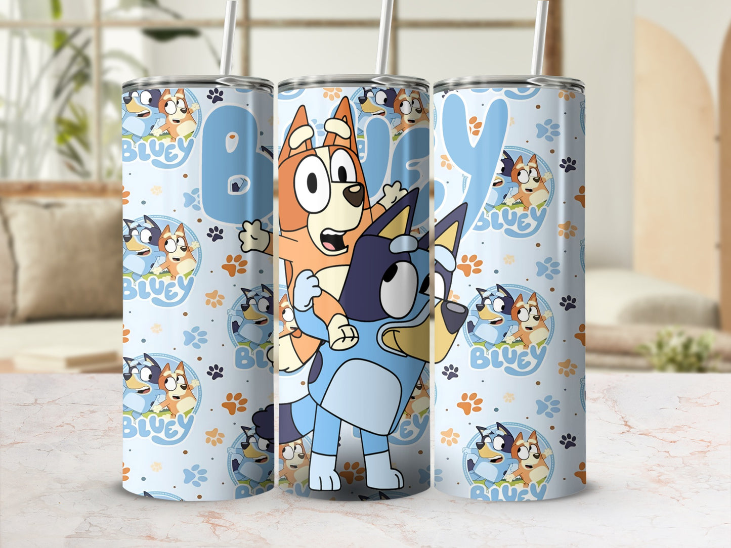 Bluey and Bingo characters on a light blue tumbler with a repeating paw print pattern.