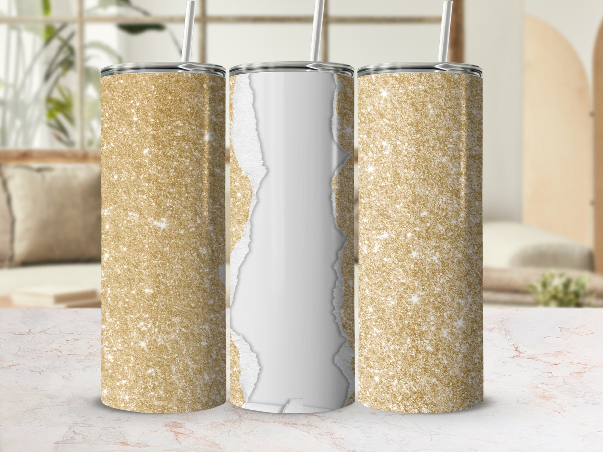 Three gold glitter tumblers with ripped paper effect on table.