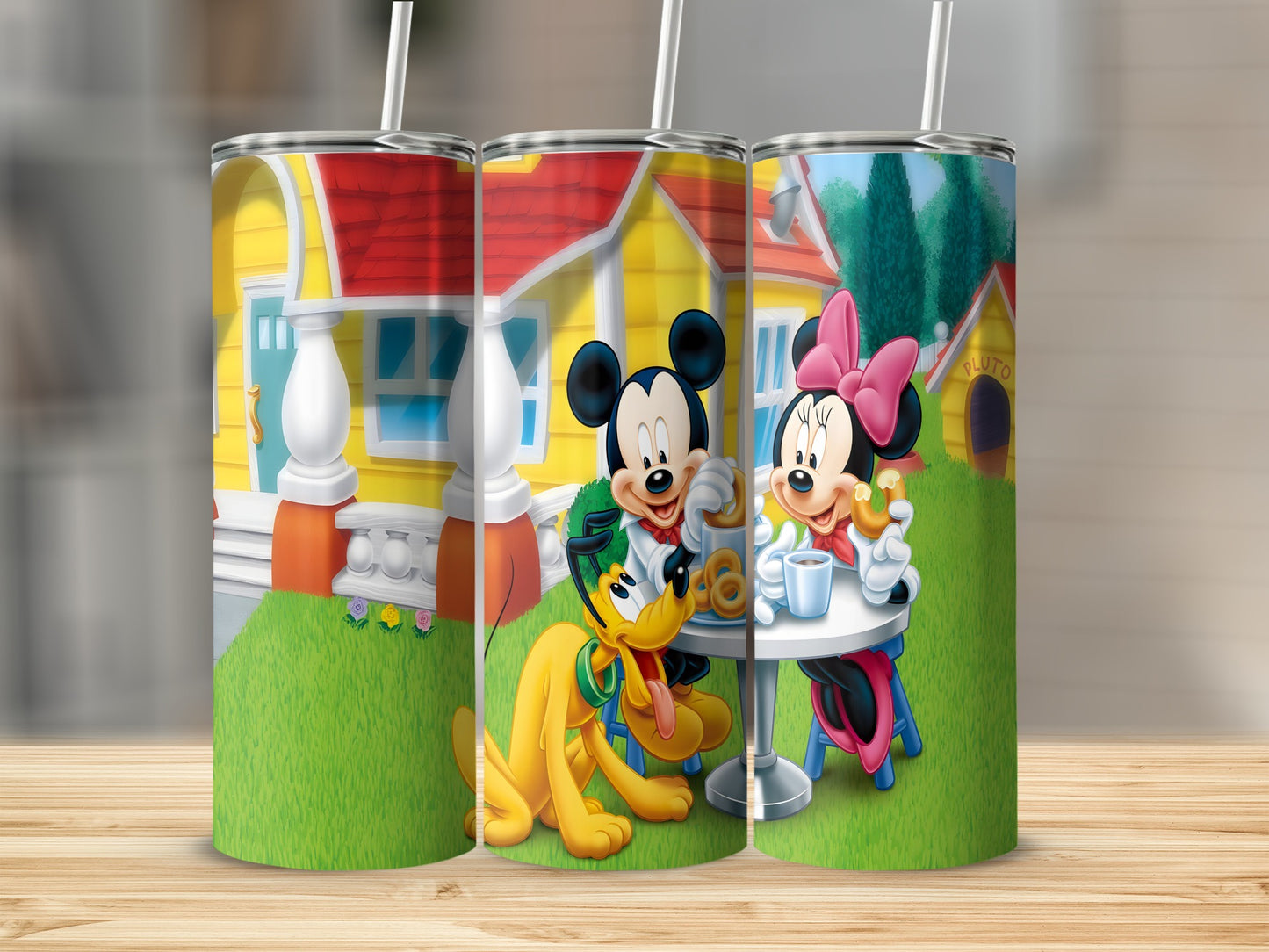 Mickey, Minnie, and Pluto enjoying drinks at a table with a house background.