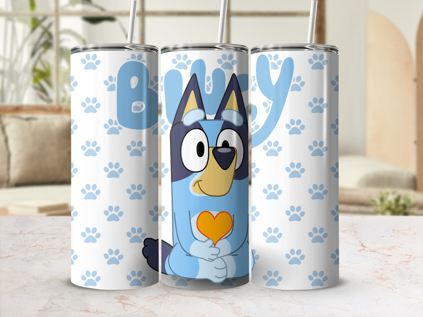 Bluey character with orange heart on a light blue tumbler with paw prints.