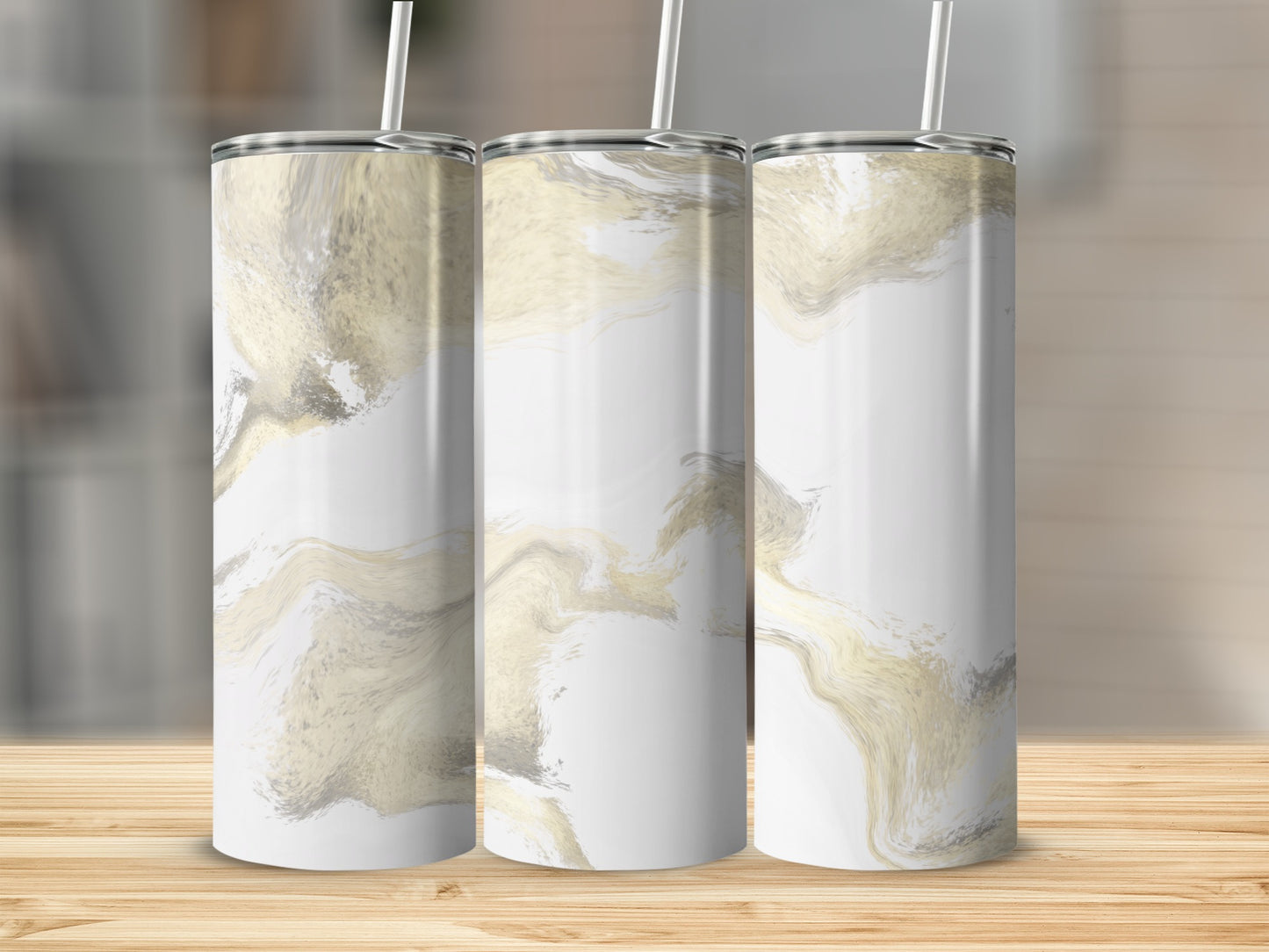 Three tall tumblers with a white and gold marble design, on a wooden surface.