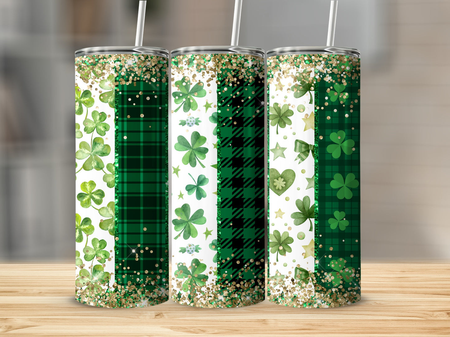 Three Saint Patrick's Day themed tumblers with shamrocks and glitter.