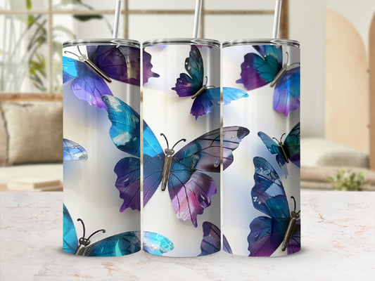 Three tumblers featuring iridescent blue and purple butterflies on a white background.
