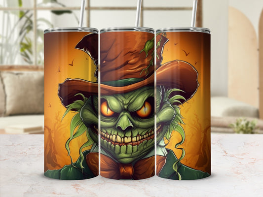 Green monster with creepy grin, orange hat, and bow tie on a tumbler.