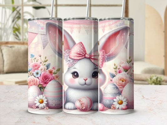 Easter bunny with pink bow, flowers, and decorated eggs on tumblers.