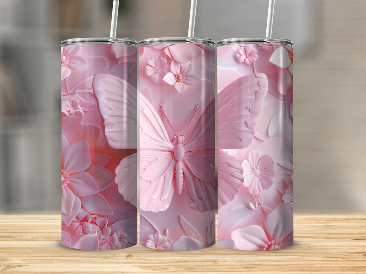 Pink butterfly and floral pattern on three tumblers.