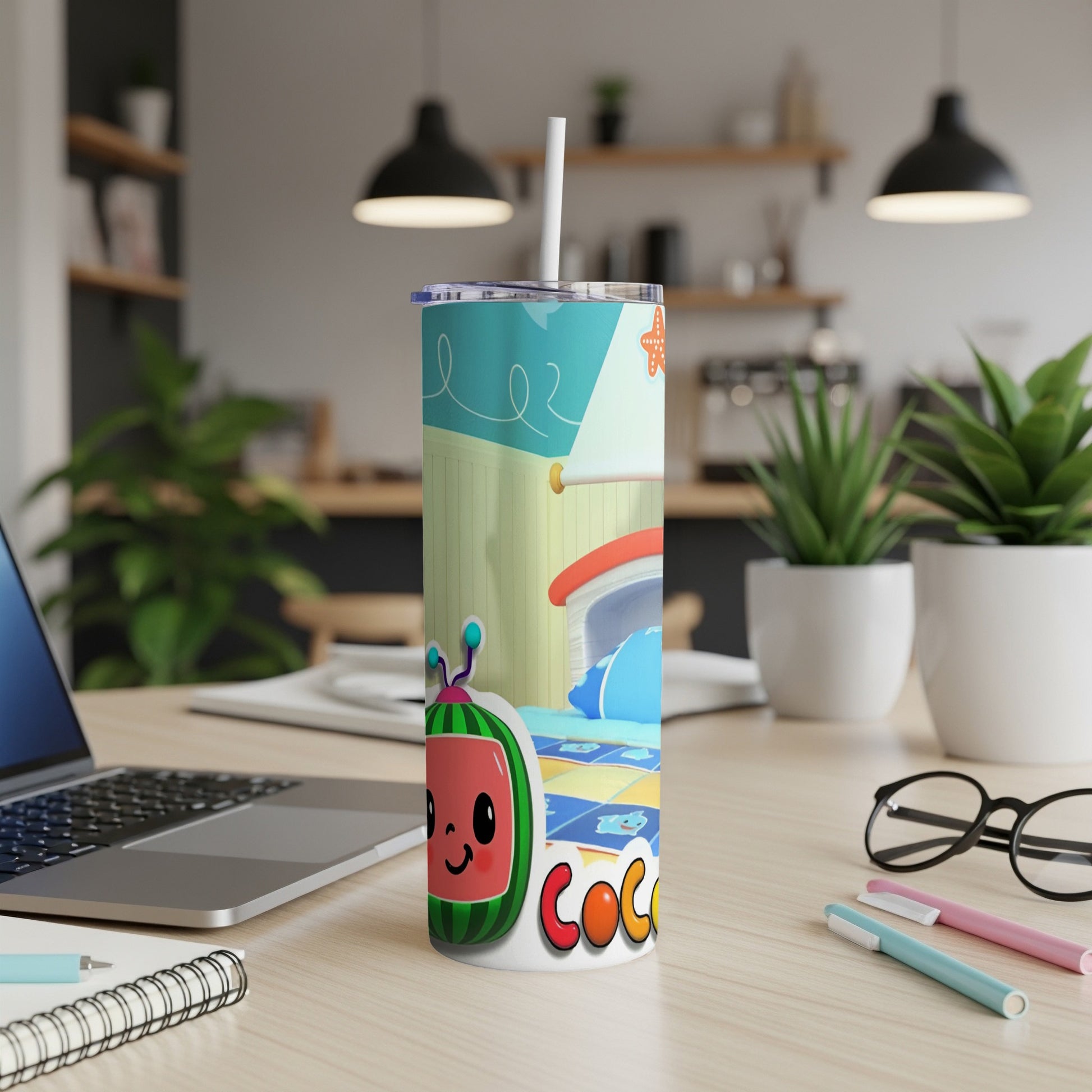 Cocomelon character on a tumbler with a straw, on a desk.