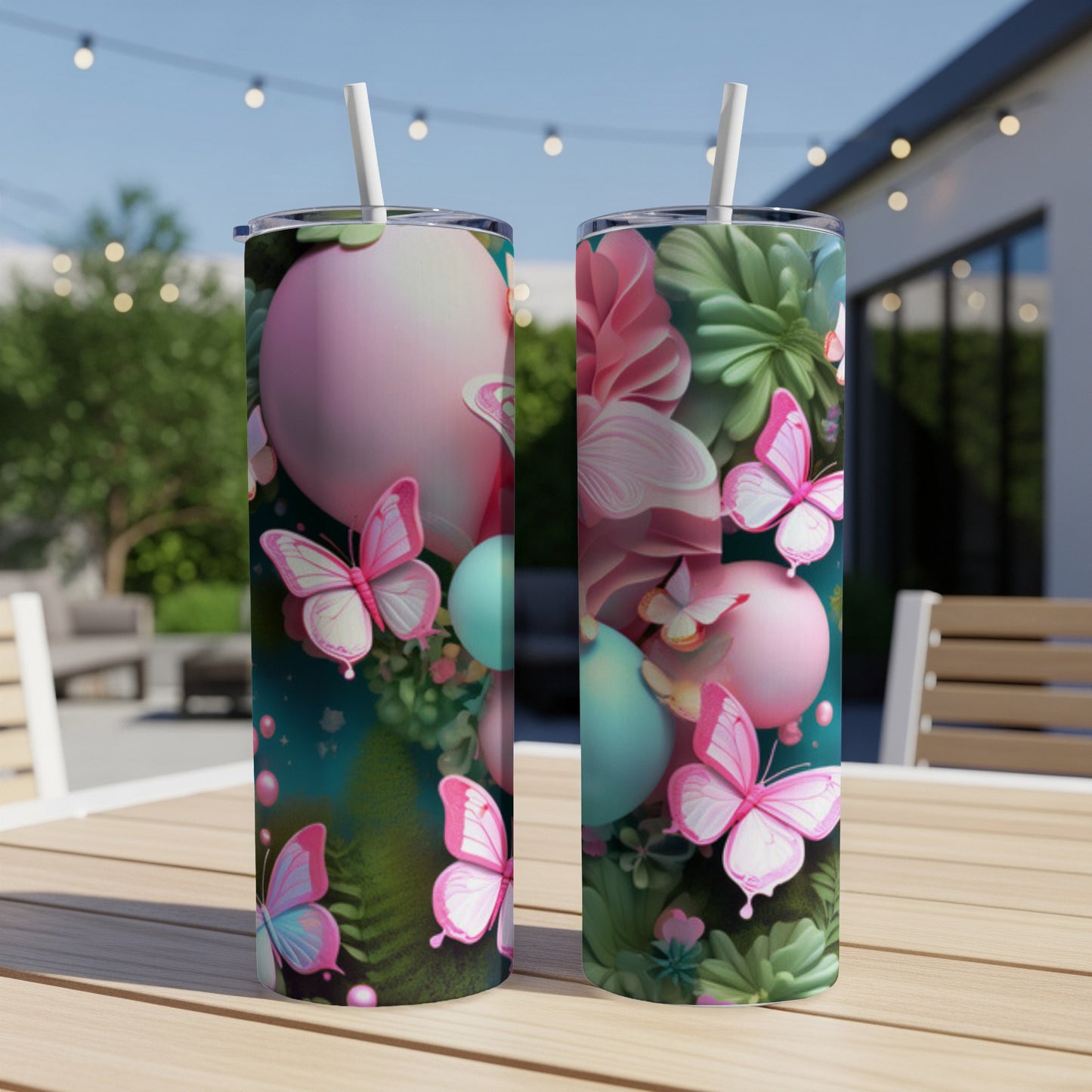 Two pink and teal patterned tumblers with butterflies and floral designs on a table.