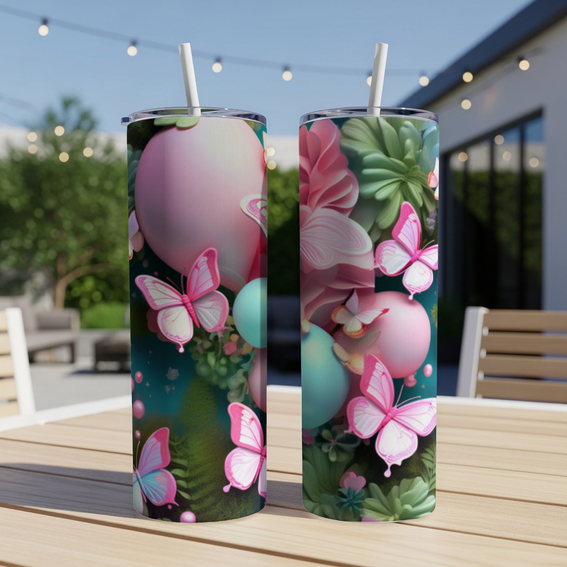 Two pink and teal patterned tumblers with butterflies and floral designs on a table.