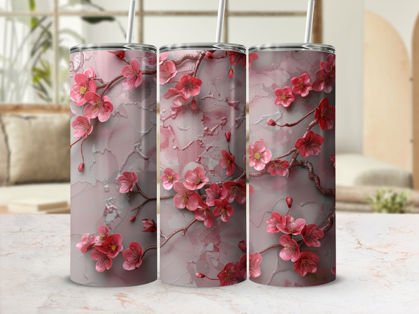 Pink floral branches on a marble-textured tumbler with a straw.