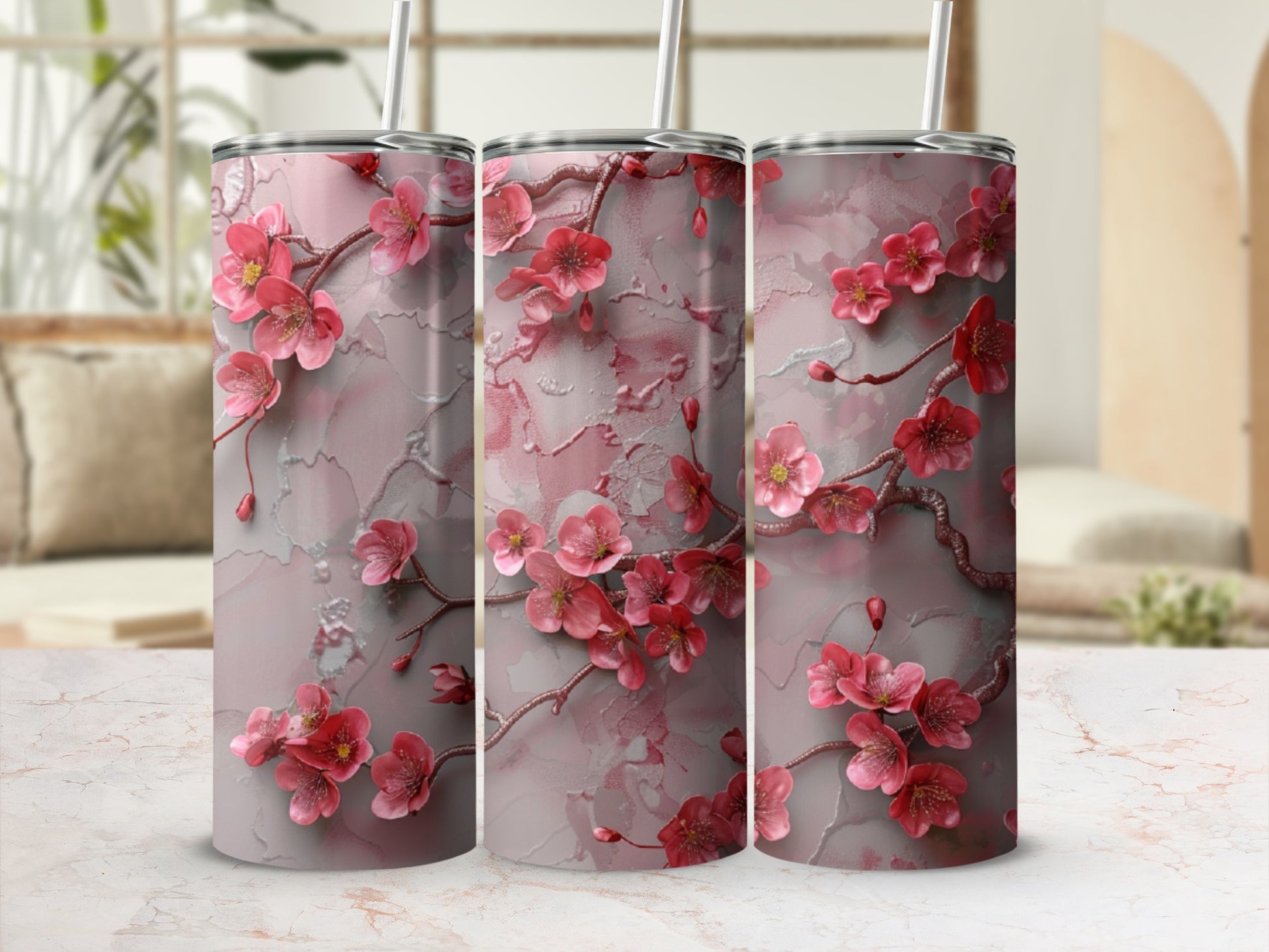 Pink floral branches on a marble-textured tumbler with a straw.