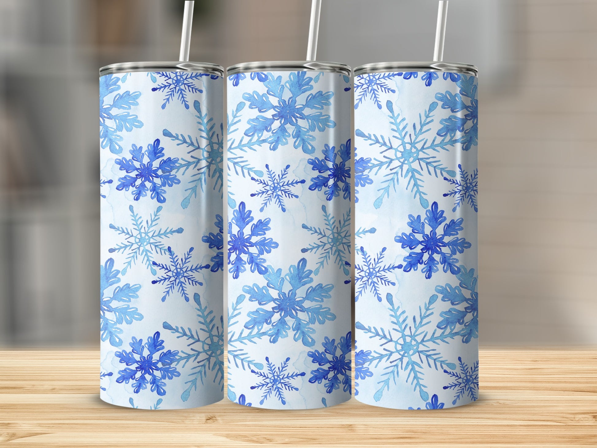 Three tumblers with a blue watercolor snowflake pattern.
