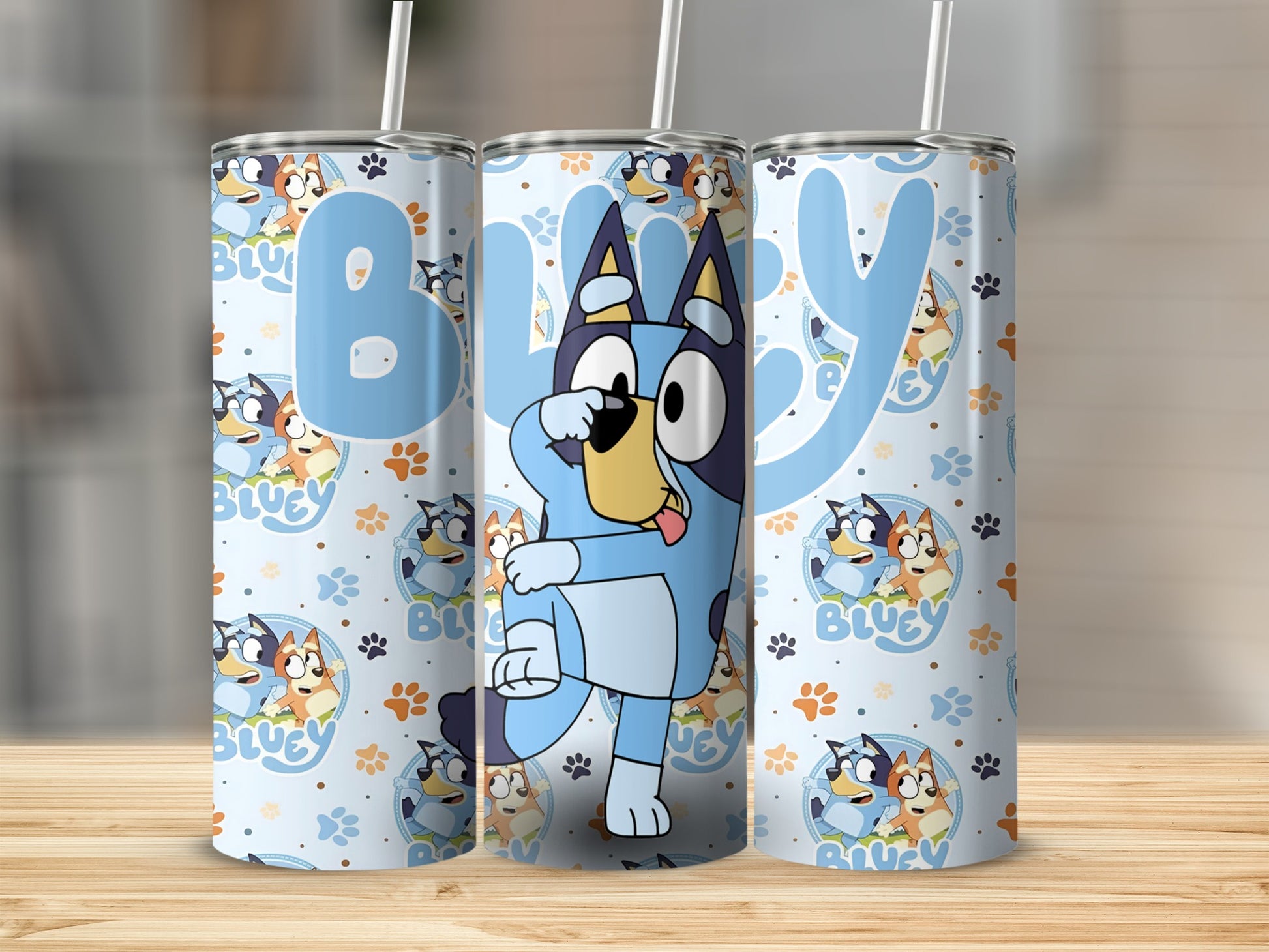 Bluey cartoon dog tumbler with blue background and paw prints.