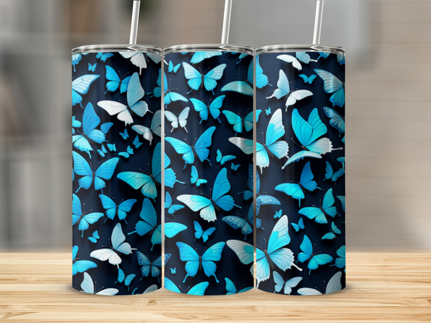 Three tumblers with a blue butterfly pattern, standing on a wooden surface.