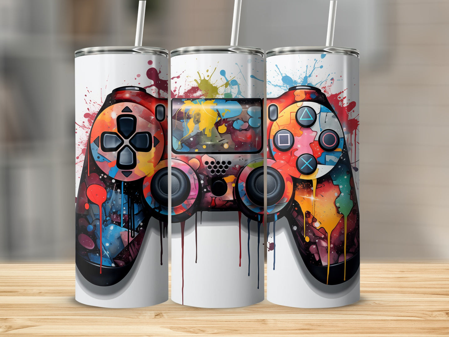 Three white tumblers featuring colorful, abstract video game controllers.