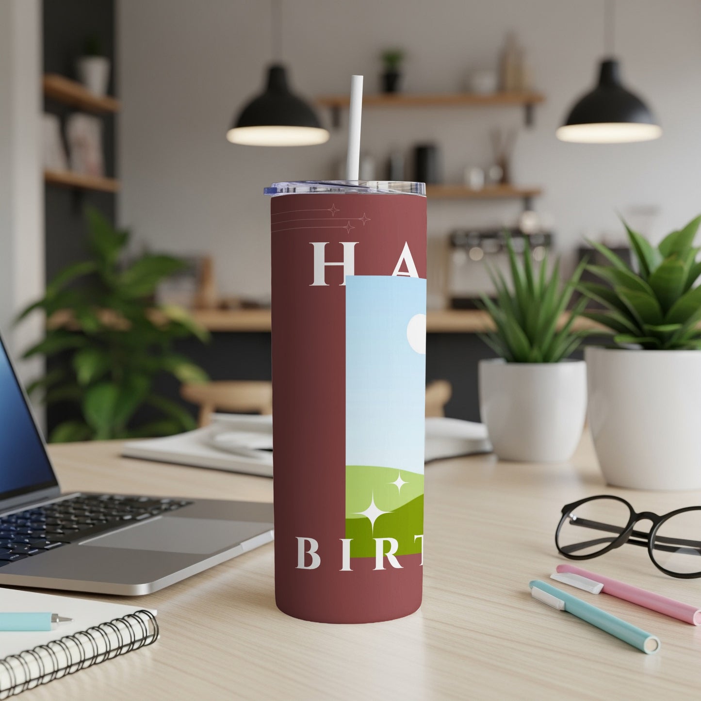 Maroon tumbler with "Happy Birthday" text and a landscape design.