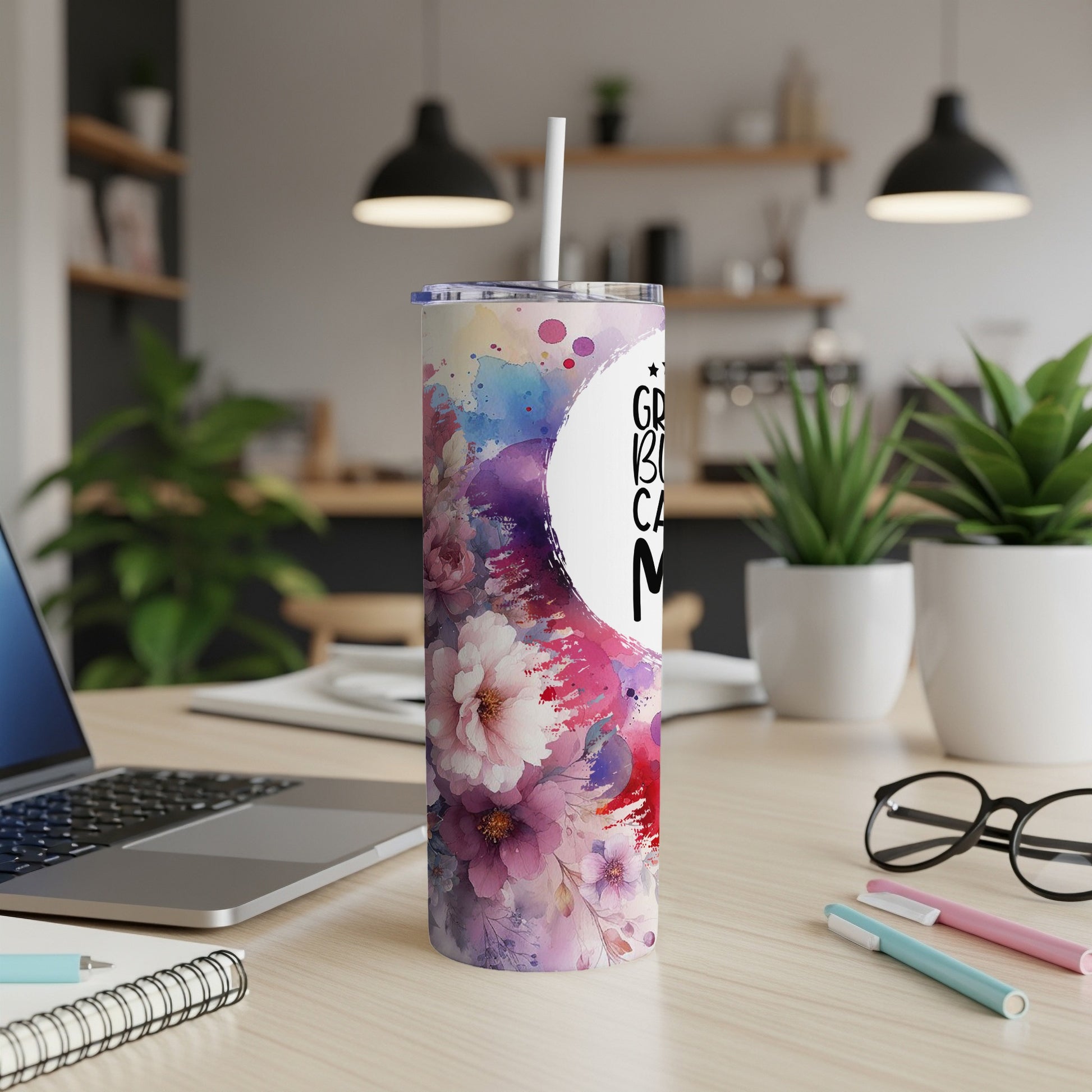Floral tumbler with "Great Big Cuddle Maker" text and straw on a desk.