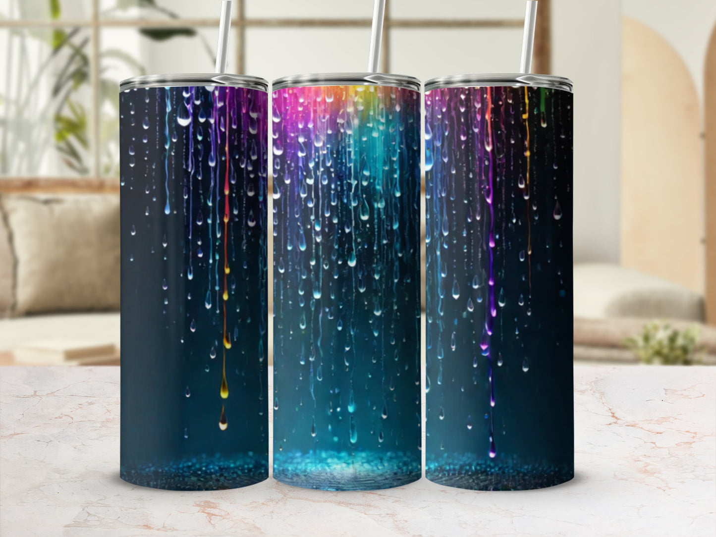 Three tumblers with colorful dripping paint design on dark background.