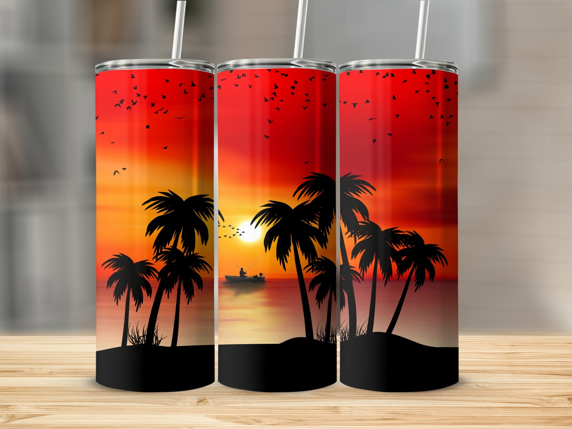 Three tumblers with a sunset beach scene and palm trees.