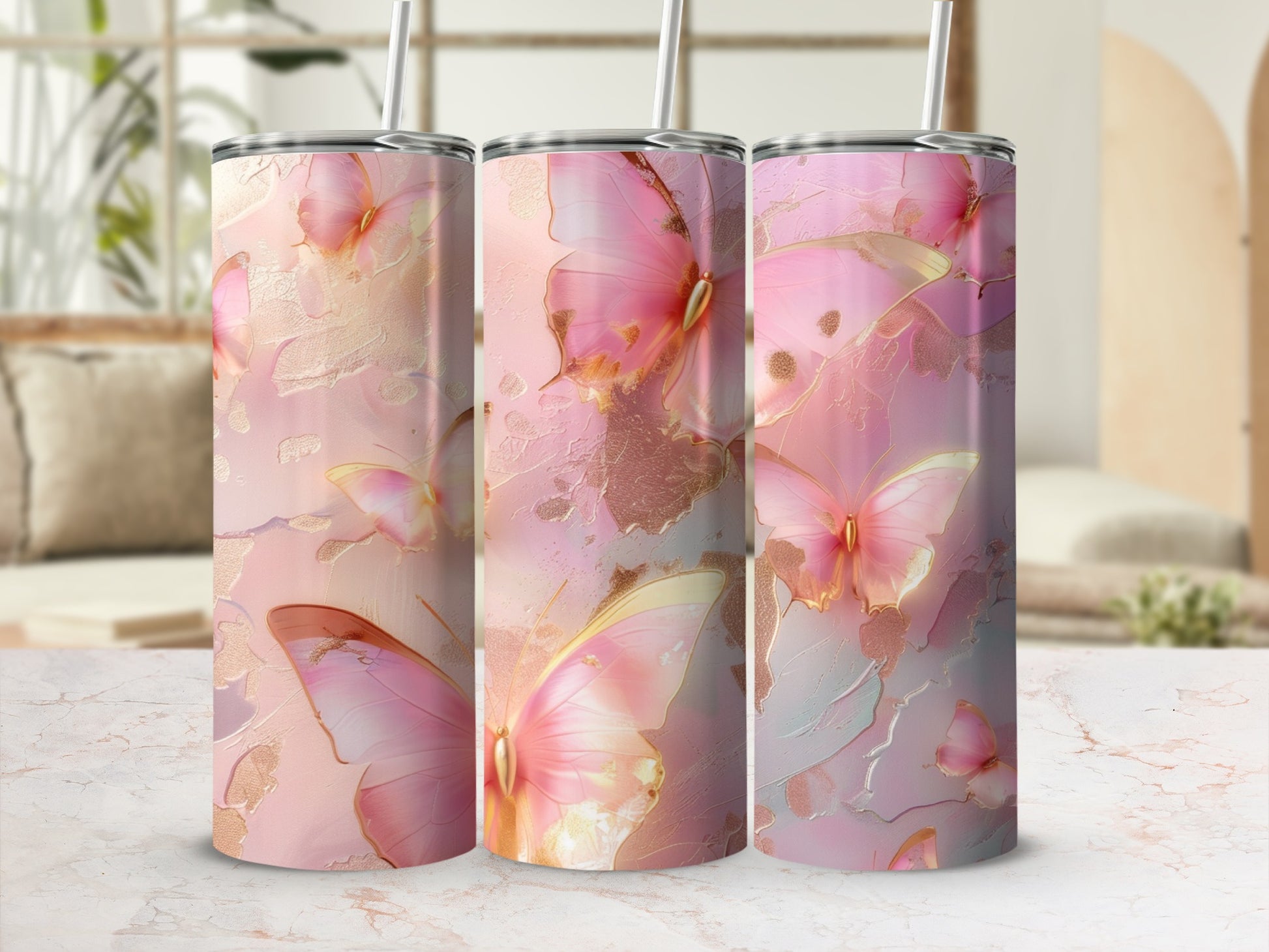 Pink butterflies and gold accents on a tumbler with a marble background.