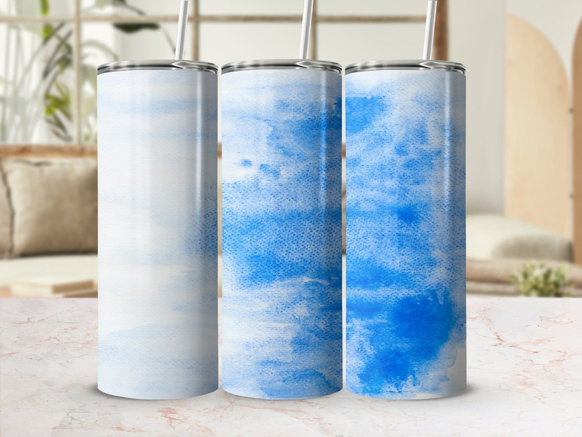 Three tumblers with light blue watercolor abstract designs.