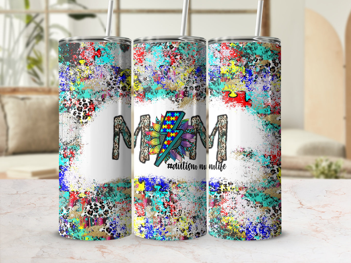 Tumbler with rainbow autism puzzle piece and "Mom" text on colorful abstract background.