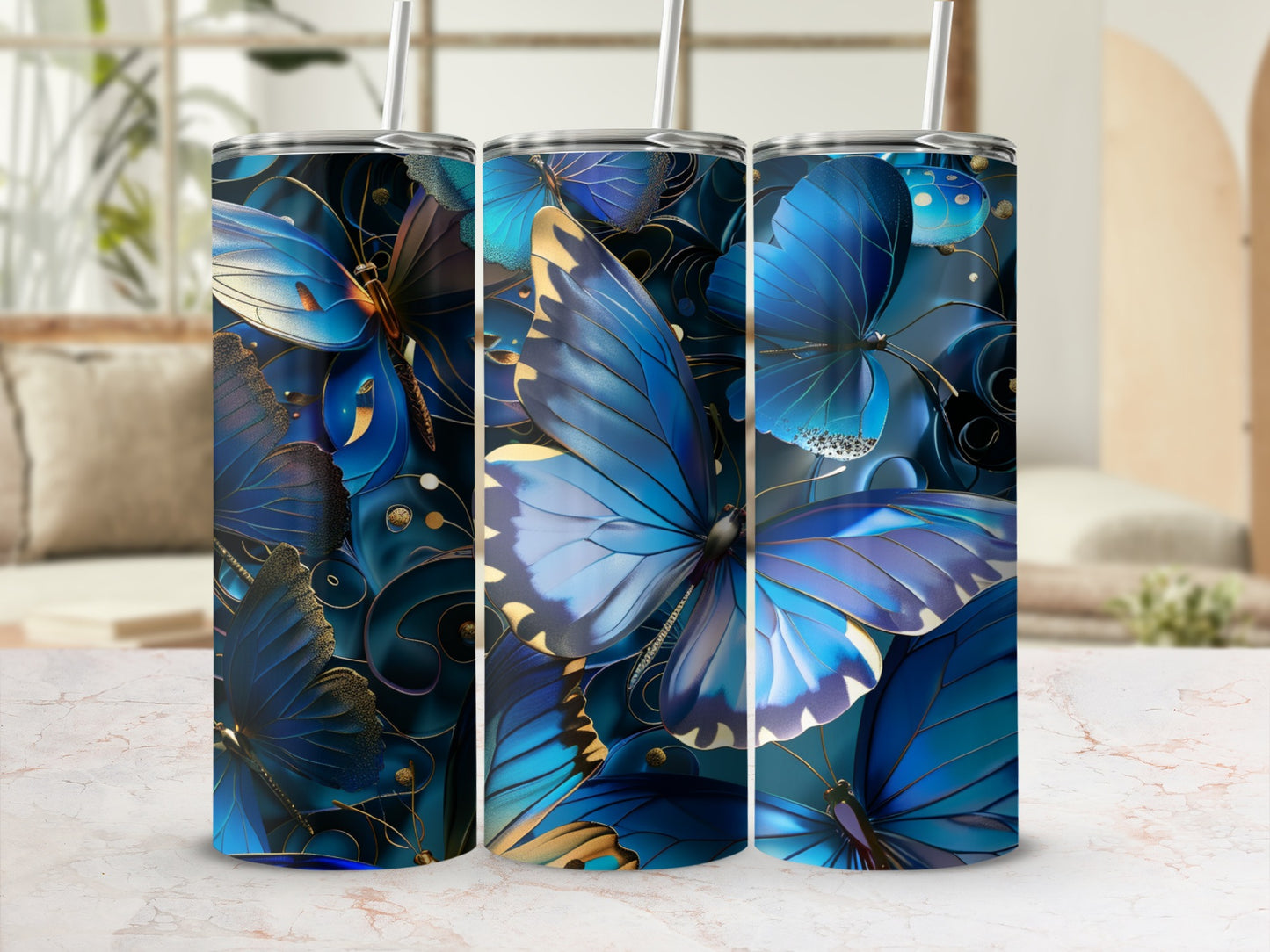 Three blue butterfly tumblers with gold accents and straw.