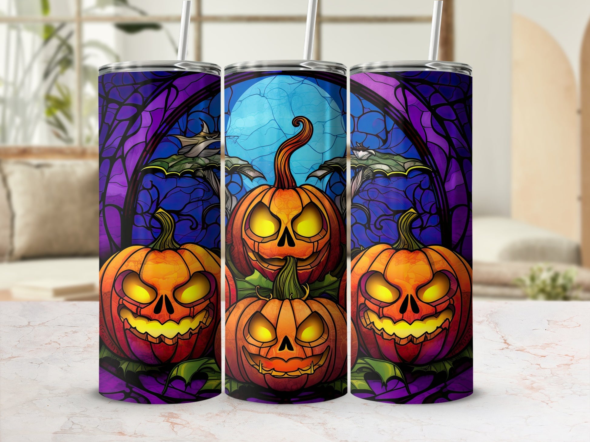 Three tumblers with a Halloween stained glass design of grinning pumpkins and bats.
