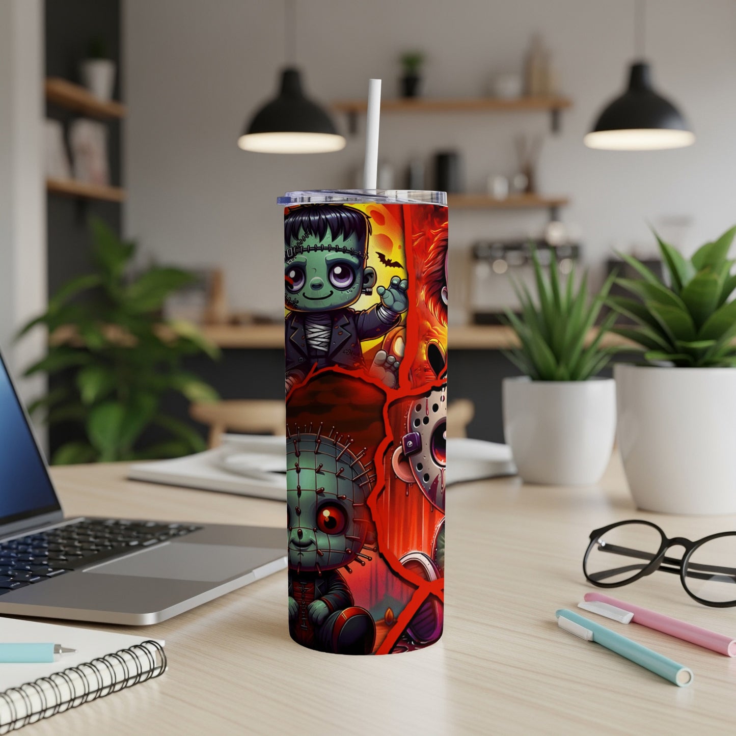 Tall tumbler with Frankenstein's monster, Pinhead, and Jason Voorhees cartoon designs.