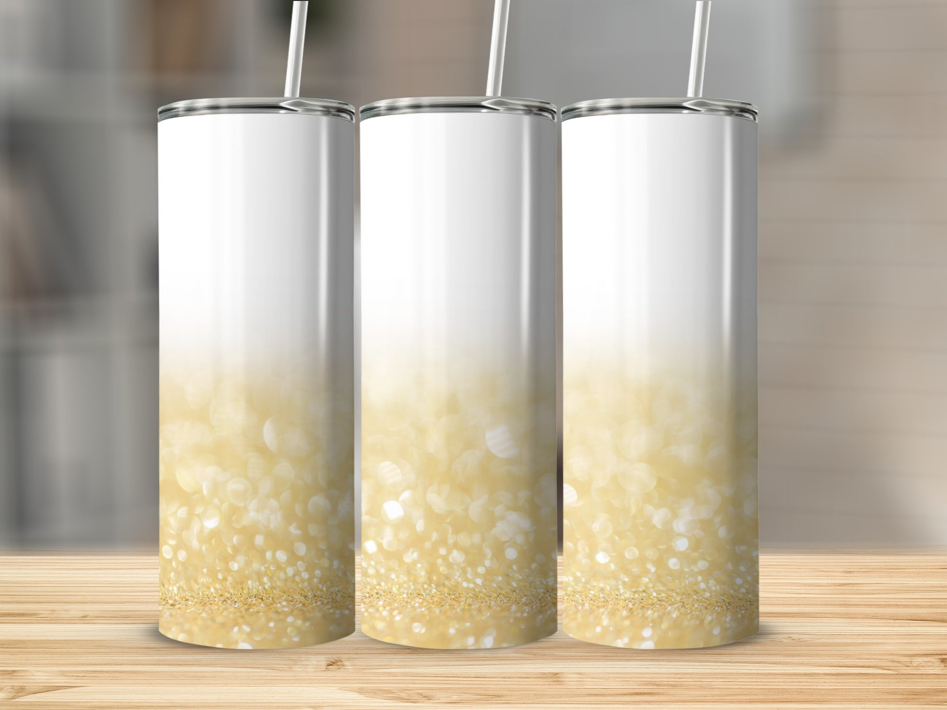 Three white tumblers with a gold glitter bokeh design, on a wooden surface.