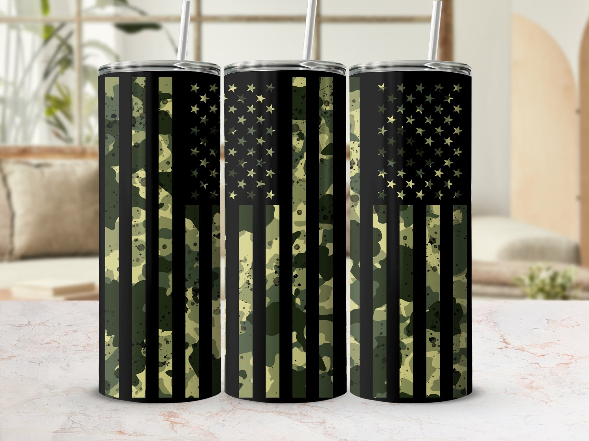 Camouflage flag tumbler set with straws on a marble surface.
