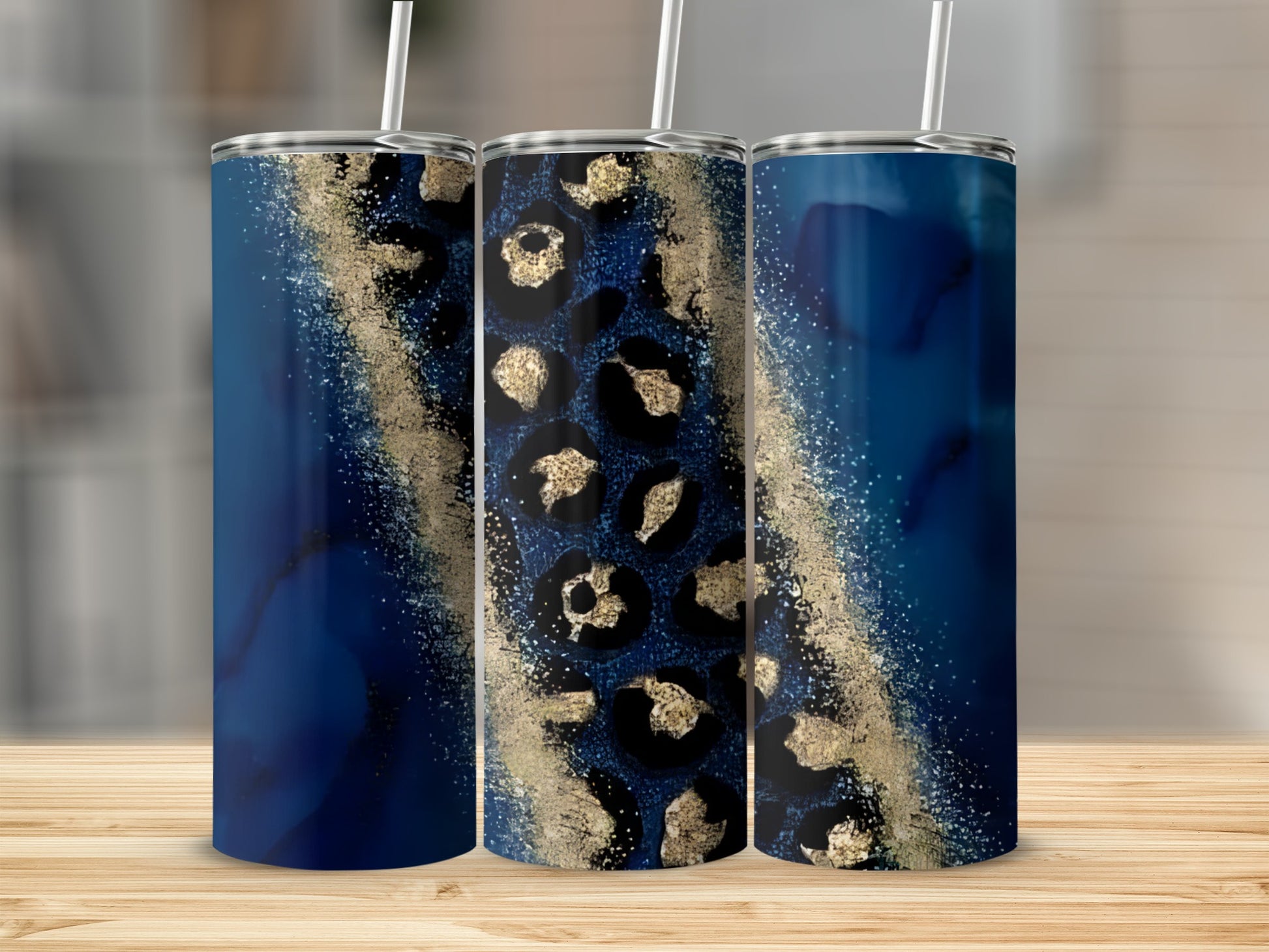 Three tumblers with navy blue and gold leopard print patterns.