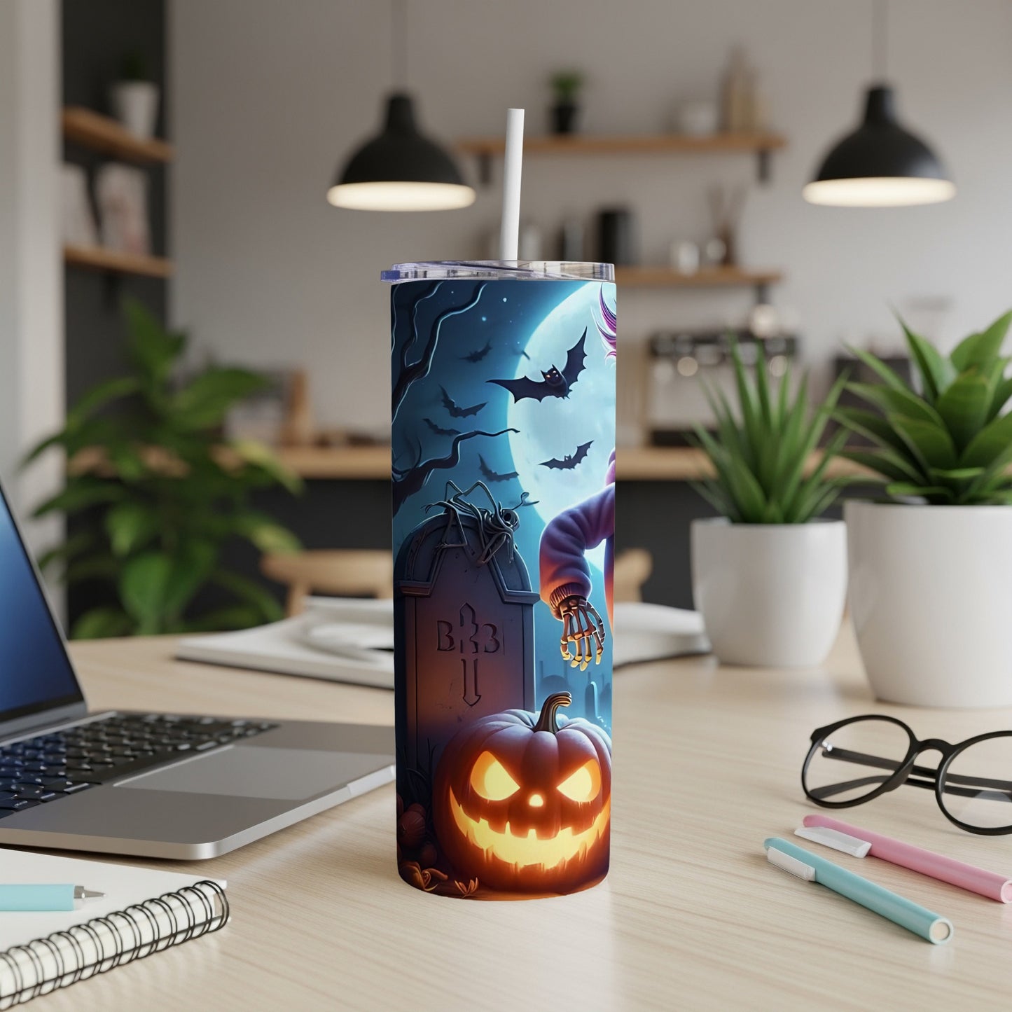 Tumbler with Halloween spooky graveyard, bats, pumpkin, and skeleton hand design.