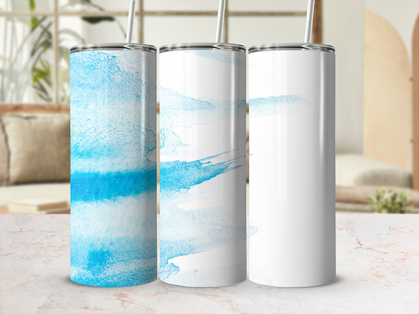 Three tumblers with blue watercolor designs and one plain white tumbler.