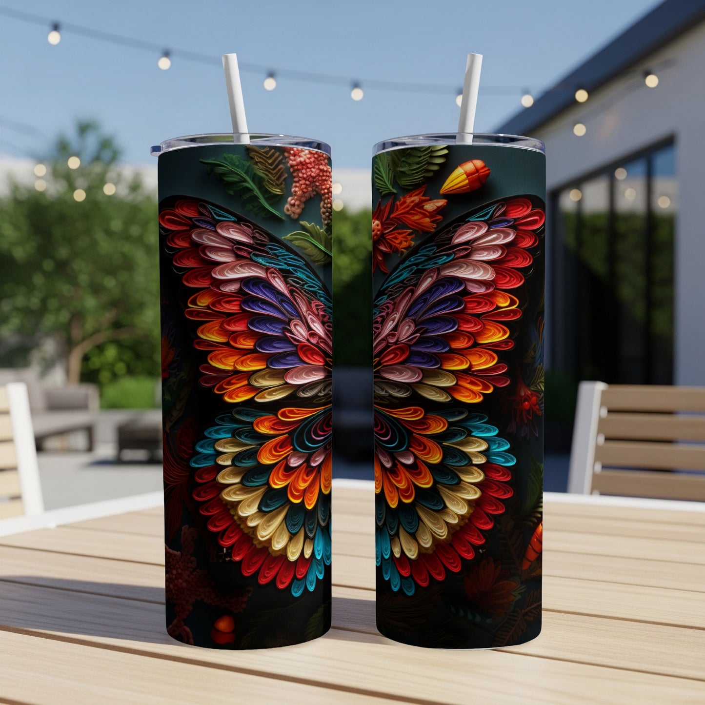 Two tumblers with colorful butterfly wing designs sit on a table.