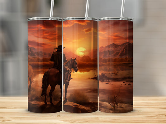 Cowboy on horseback watches a sunset over a desert lake.