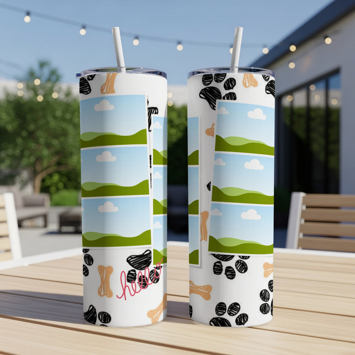 Two tumblers with paw prints, bones, and photo frames on a wooden table.