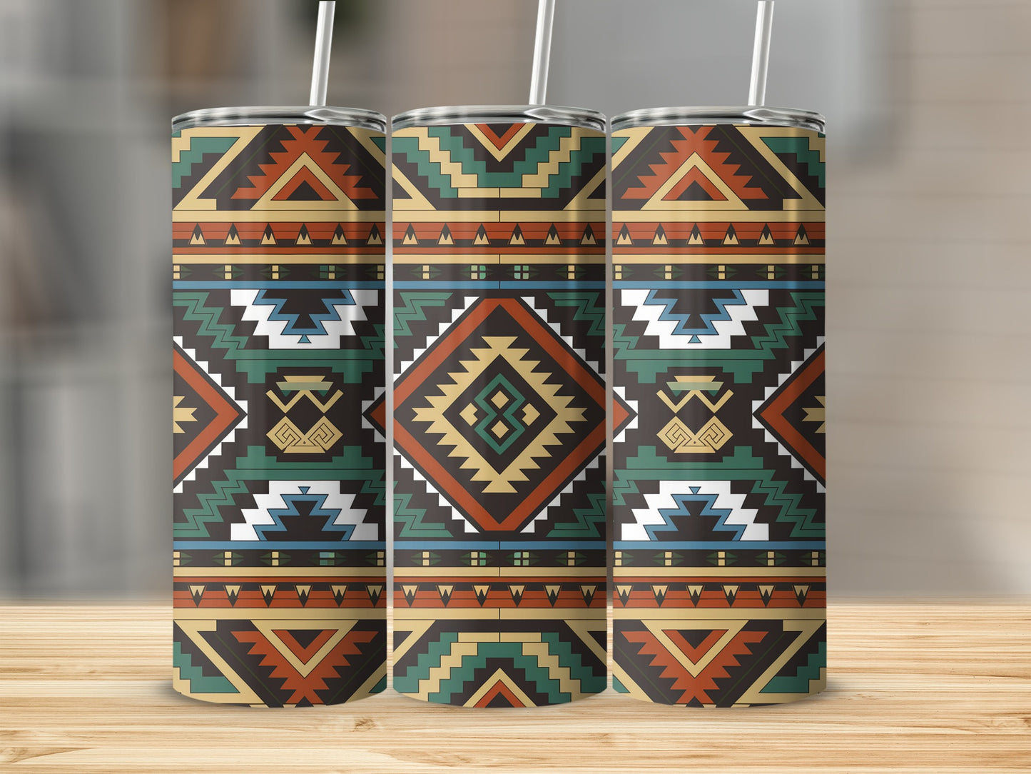 Three tumblers with a geometric southwestern tribal pattern on a wooden surface.