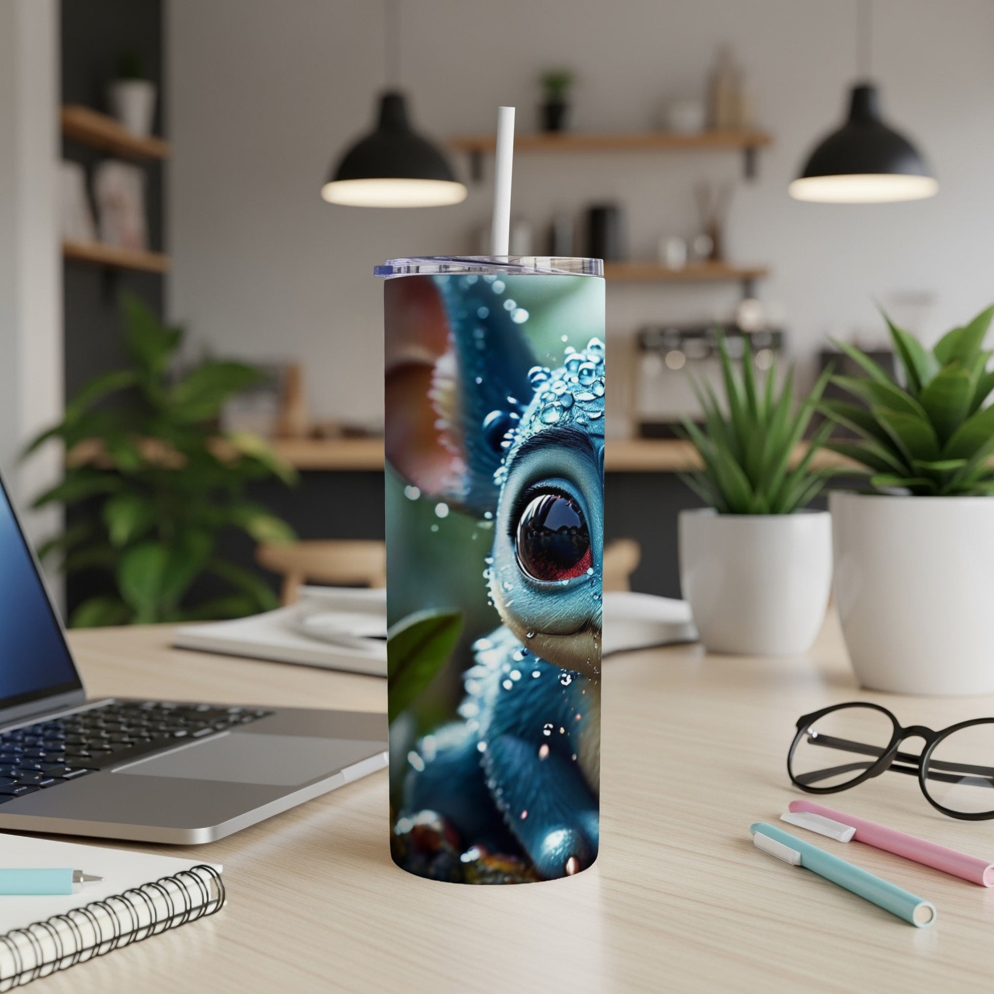 Blue cartoon creature with big eyes on a tumbler with straw.