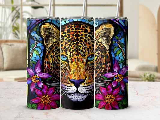 Stained glass leopard face framed by purple flowers on a tumbler.