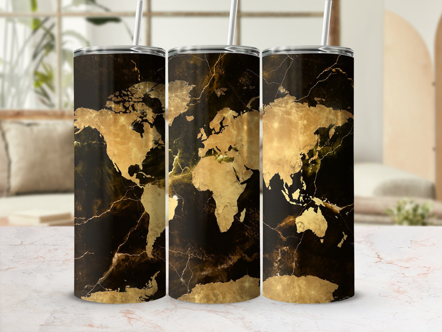 Three tumblers with a gold world map design on a black marble background.