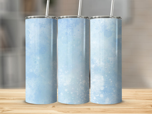 Three tumblers with light blue watercolor splatter design on wooden surface.