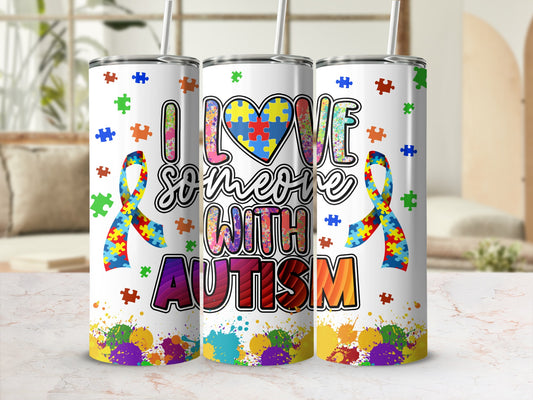 Tumbler with "I love someone with autism" text and puzzle pieces.