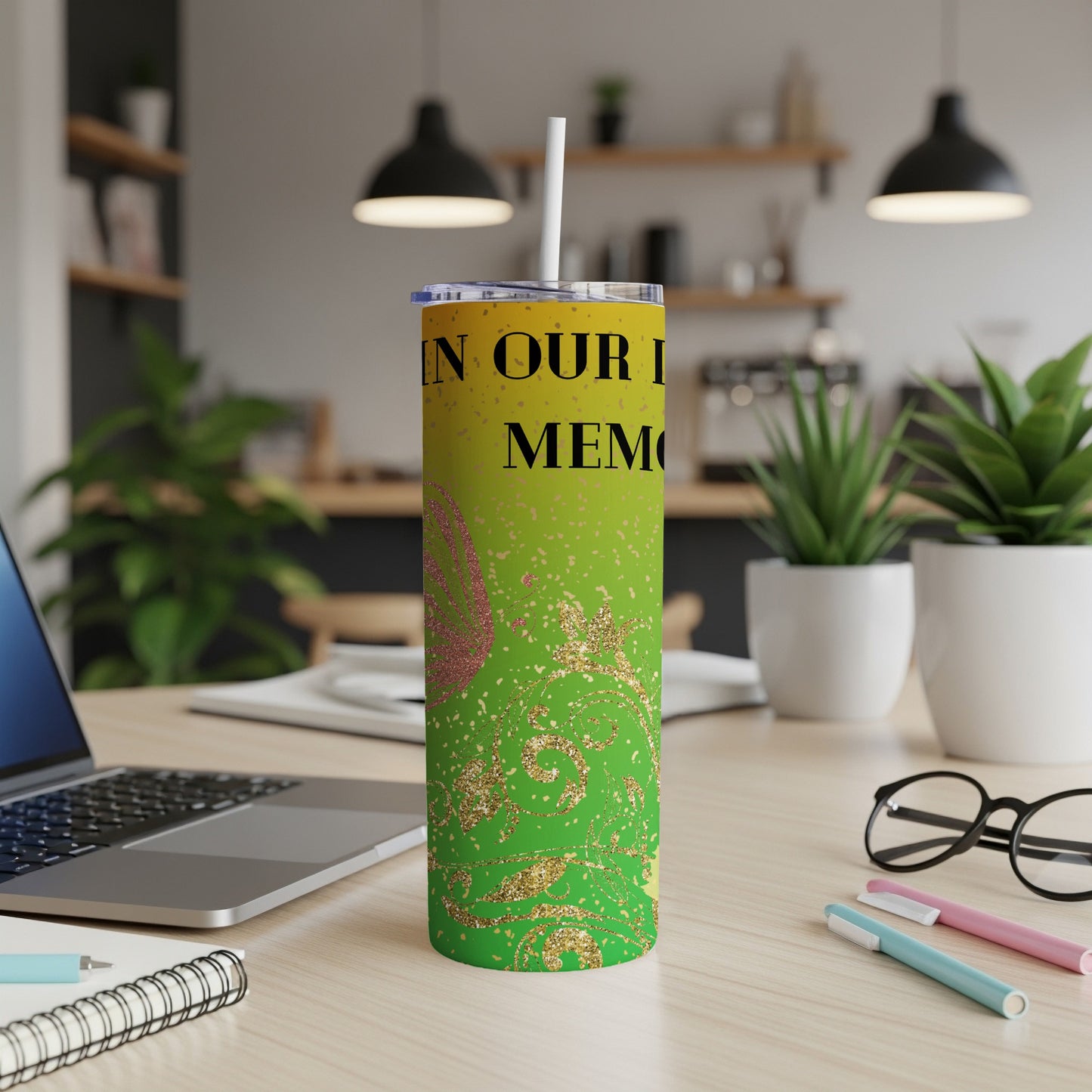 Green tumbler with "IN OUR MEMORIES" text, butterfly, and gold glitter accents.