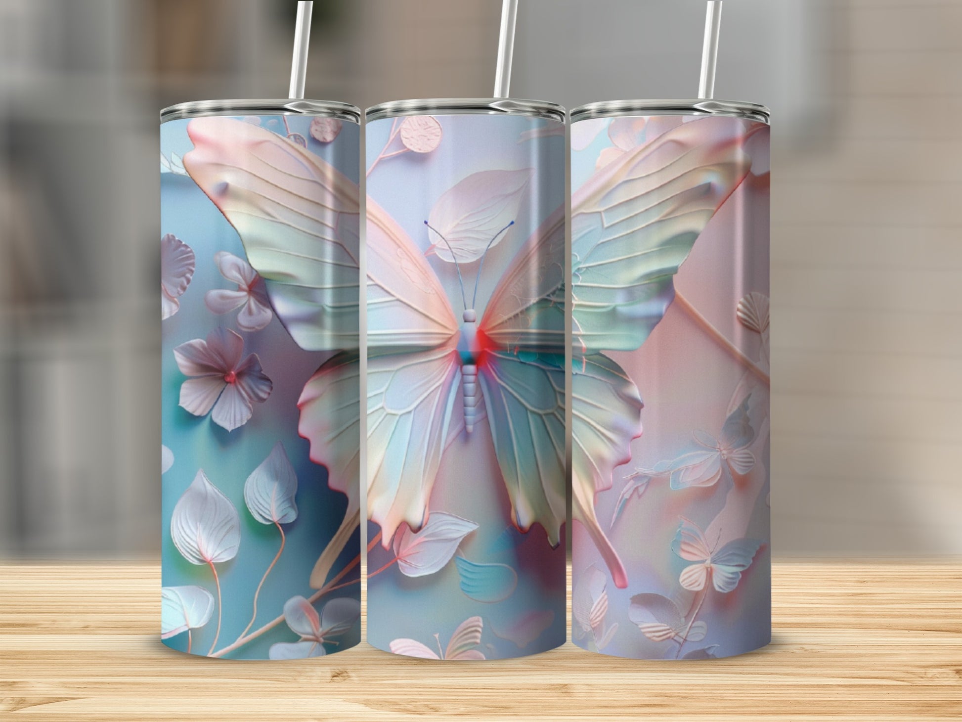 Three tumblers with pastel butterfly and floral designs.