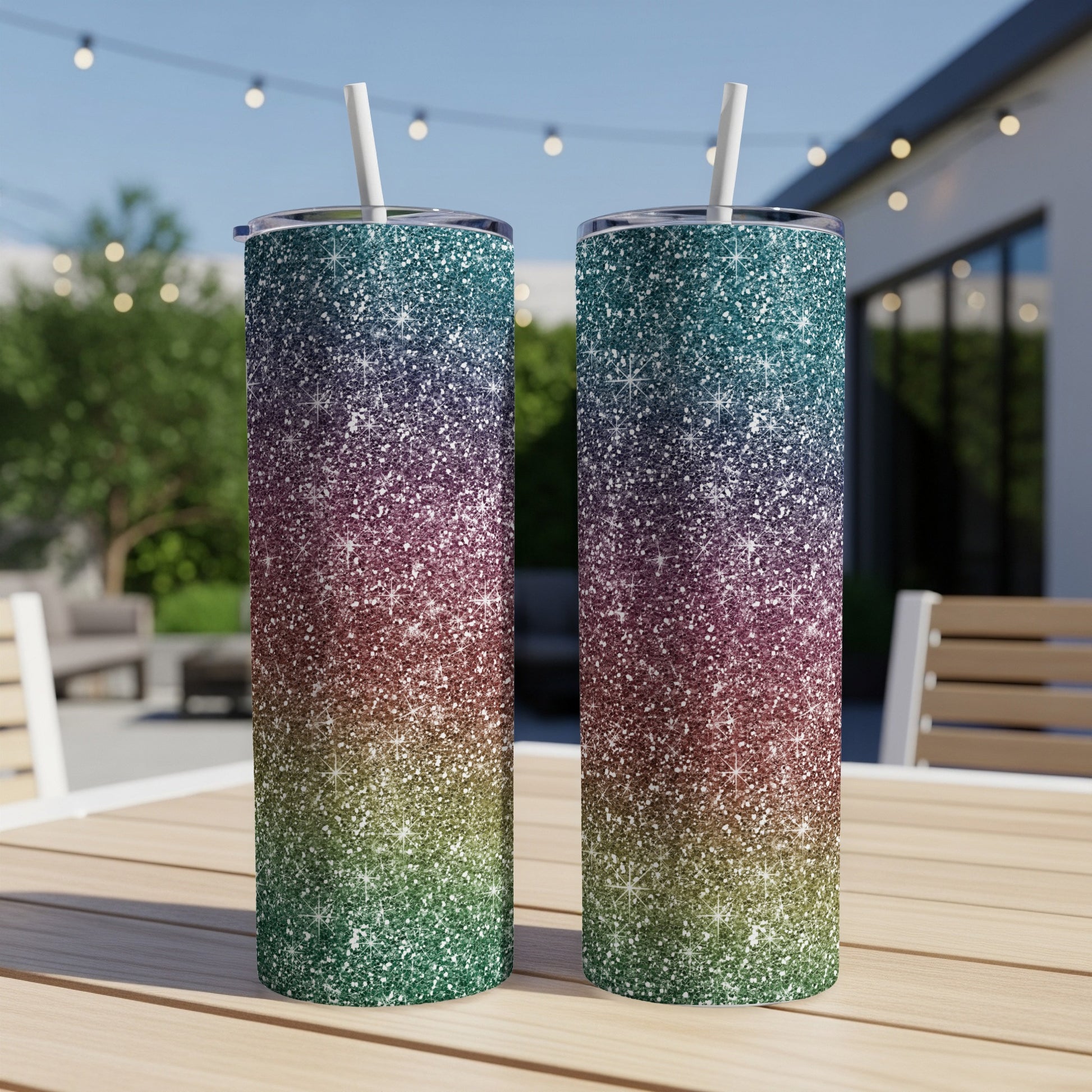 Two glitter tumblers with straws, gradient from teal to red to green.
