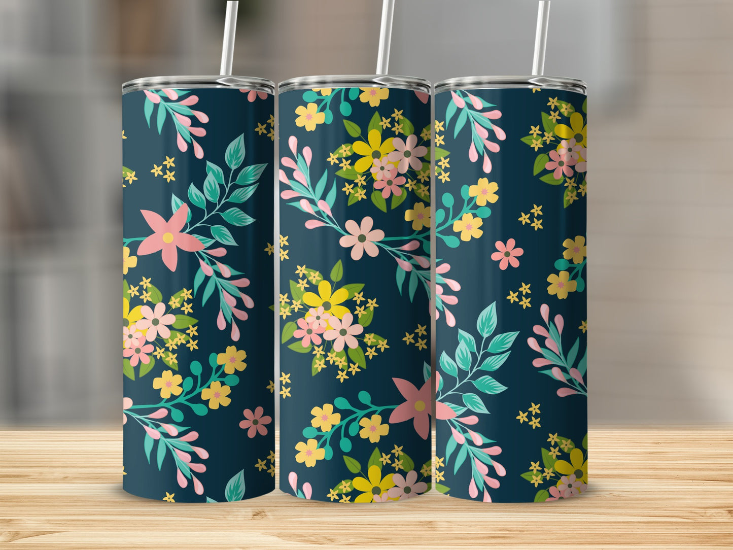 Three tumblers with a dark blue background and a floral pattern of pink, yellow, and teal flowers.